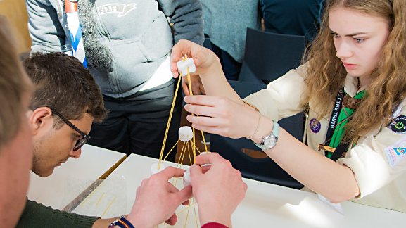 Scouts building a tower with pasta and marshmallows